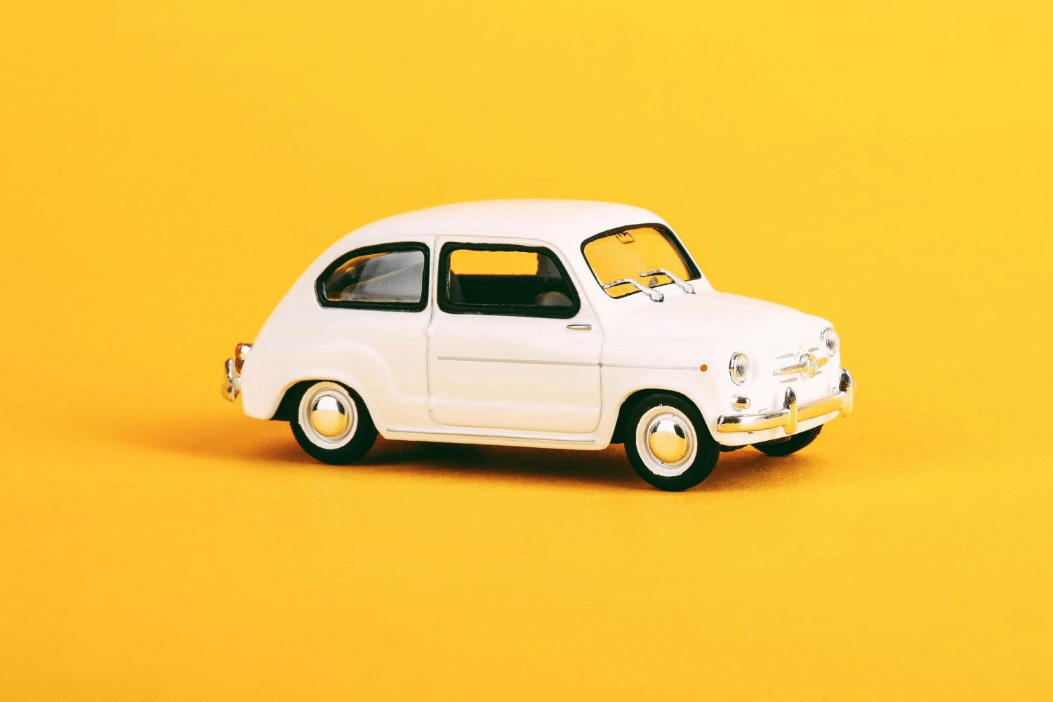 MYF Trusted Partners - image of a small white toy car on a yellow background